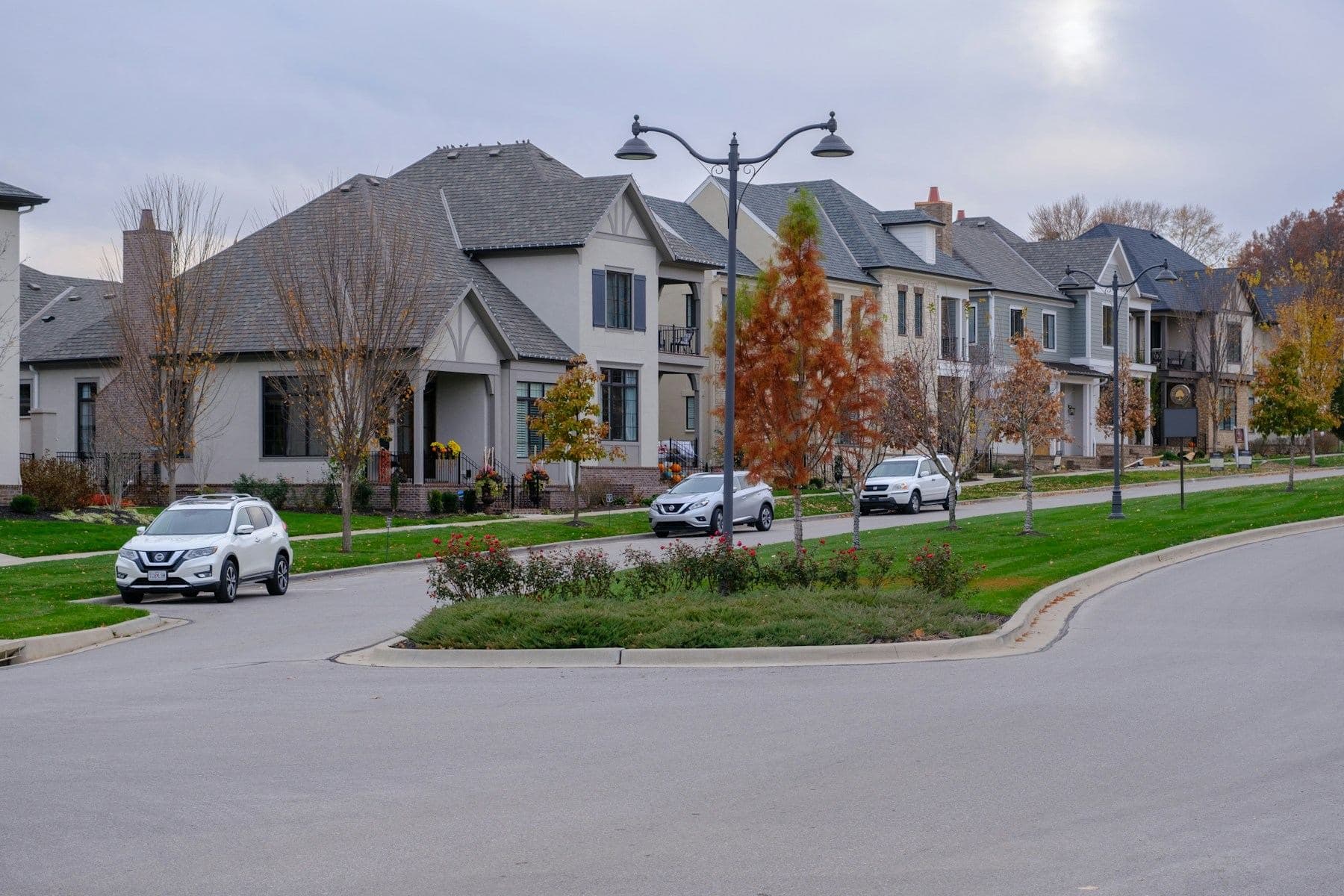 A curving street of new family homes with trees